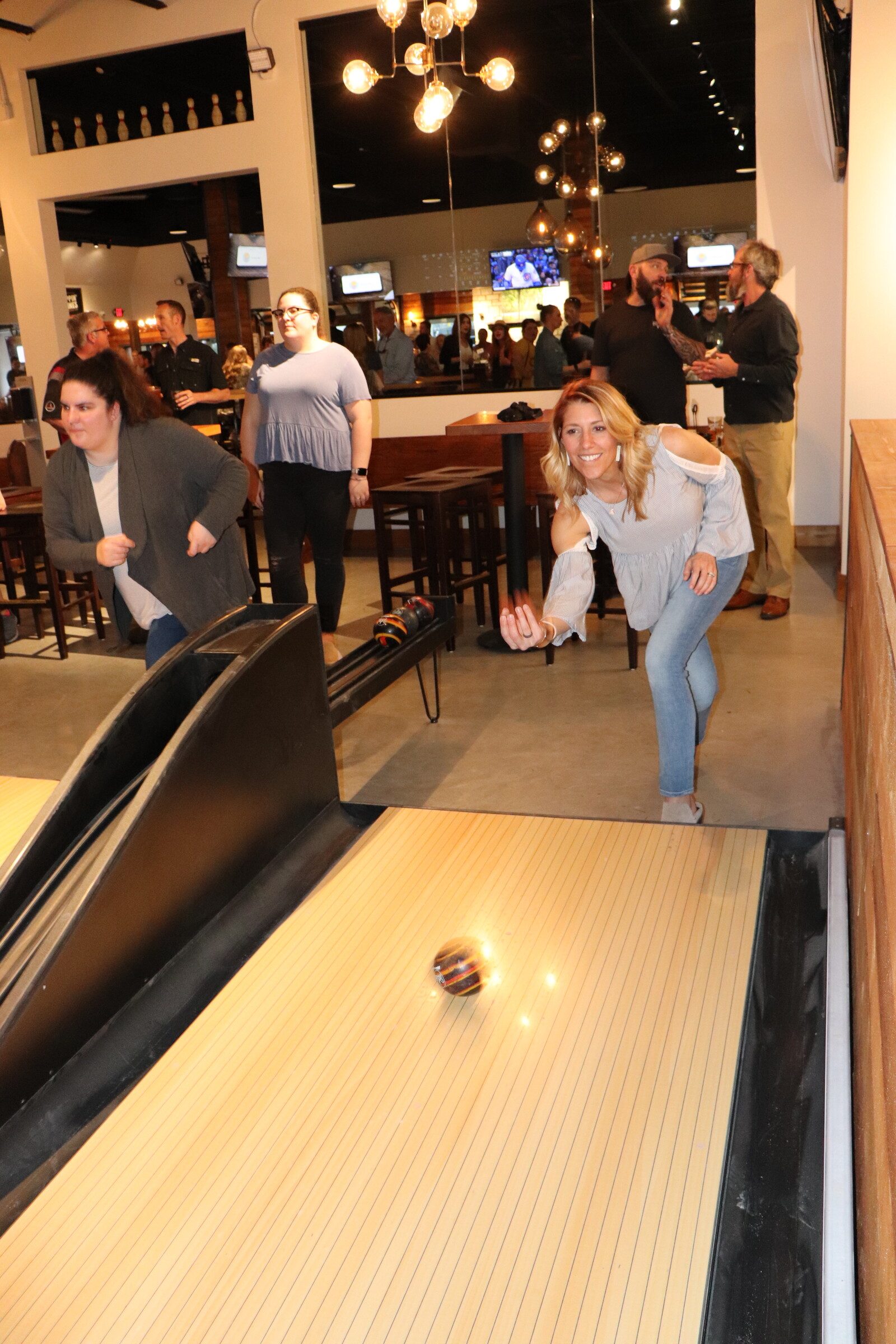 Patrons playing duckpin bowling
